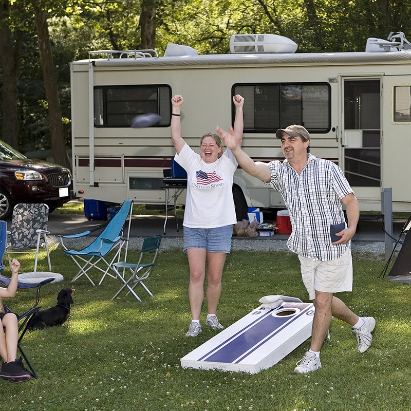 A couple play cornhole checked out from the Glenn A Jones MD Memorial Library
