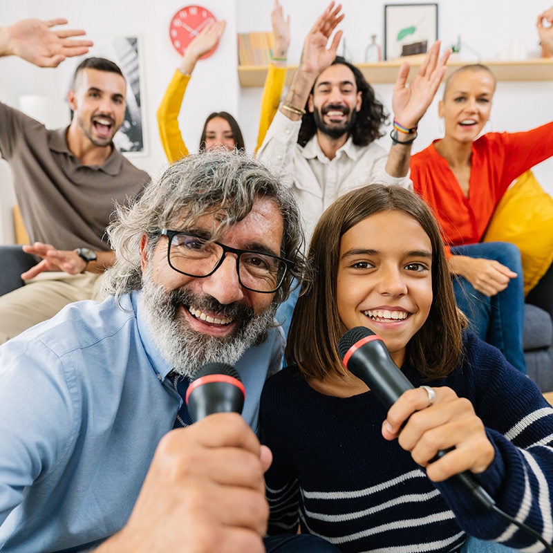 Family having fun with the karaoke machine checked out from the Glenn A Jones MD Memorial Library