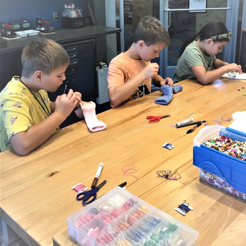 Kids make sock puppets at the Glenn A Jones MD Memorial Library Makerspace