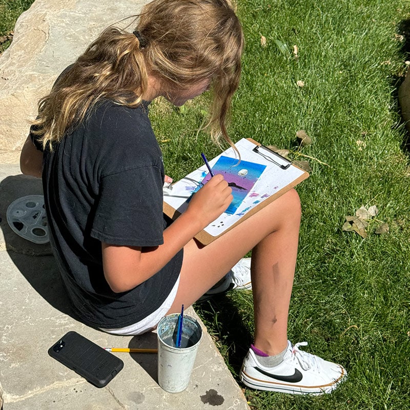 Girl painting and card-making at the Glenn A Jones MD Memorial Library Teen Programs